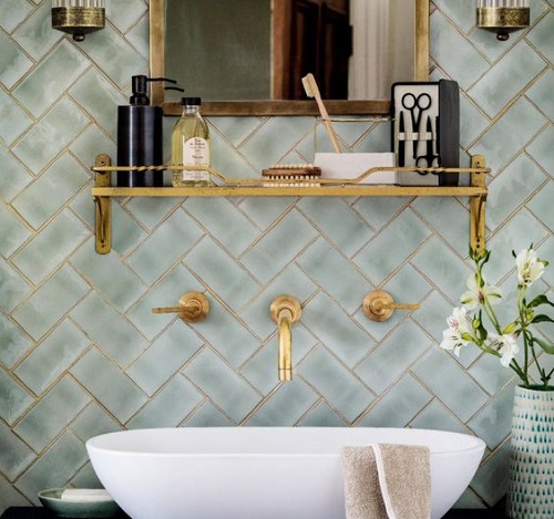 brass bathroom accessories green tiles